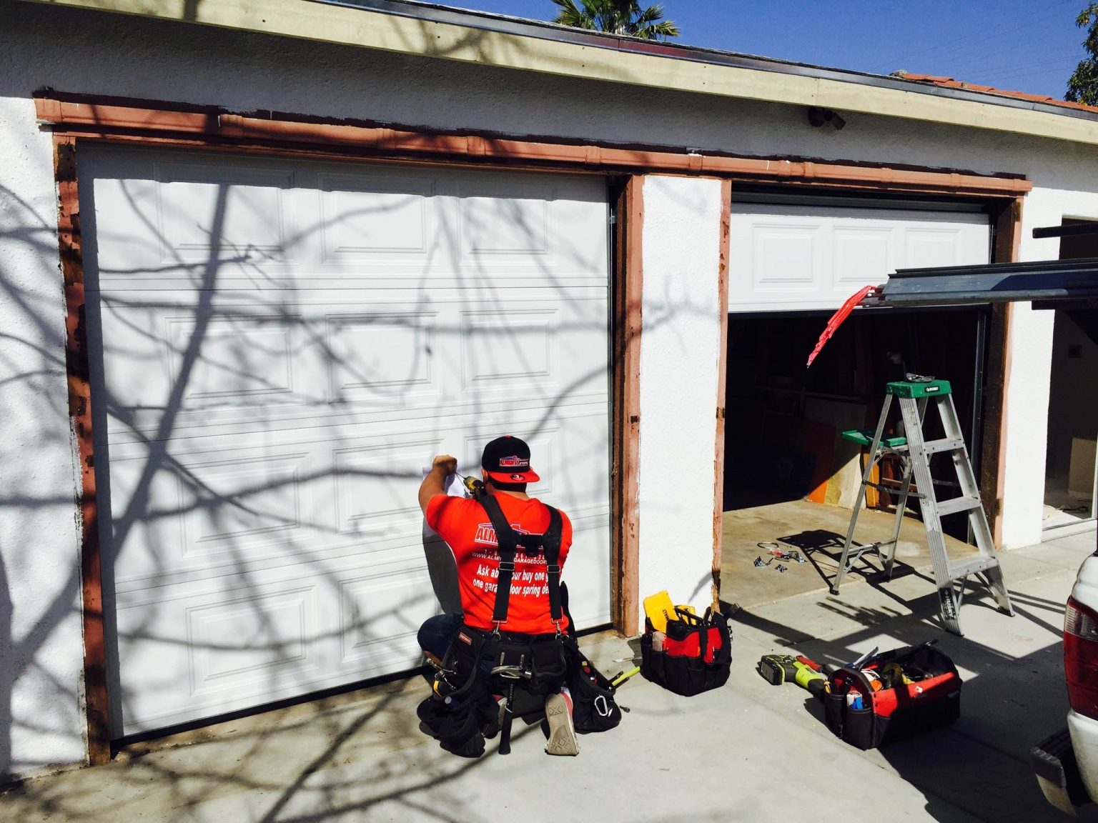Almighty technician with tools at a residential garage door